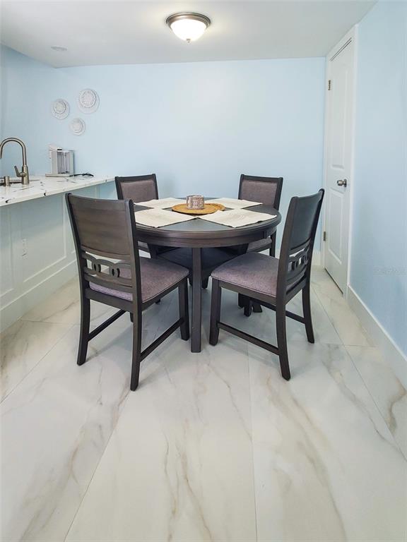215 Medallion Boulevard, Unit G Madeira Beach, FL 33708 - Photo 9 of 29 a view of a dining room with furniture