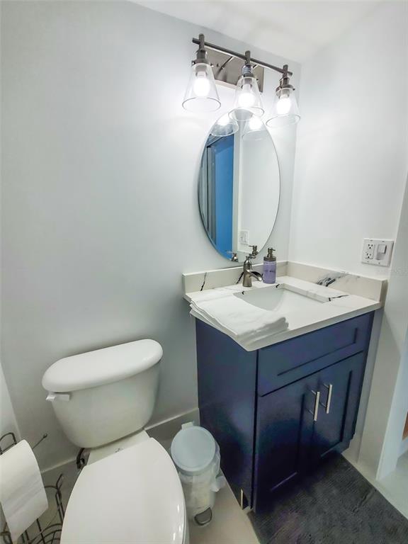 215 Medallion Boulevard, Unit G Madeira Beach, FL 33708 - Photo 10 of 29 a bathroom with a sink vanity mirror and toilet
