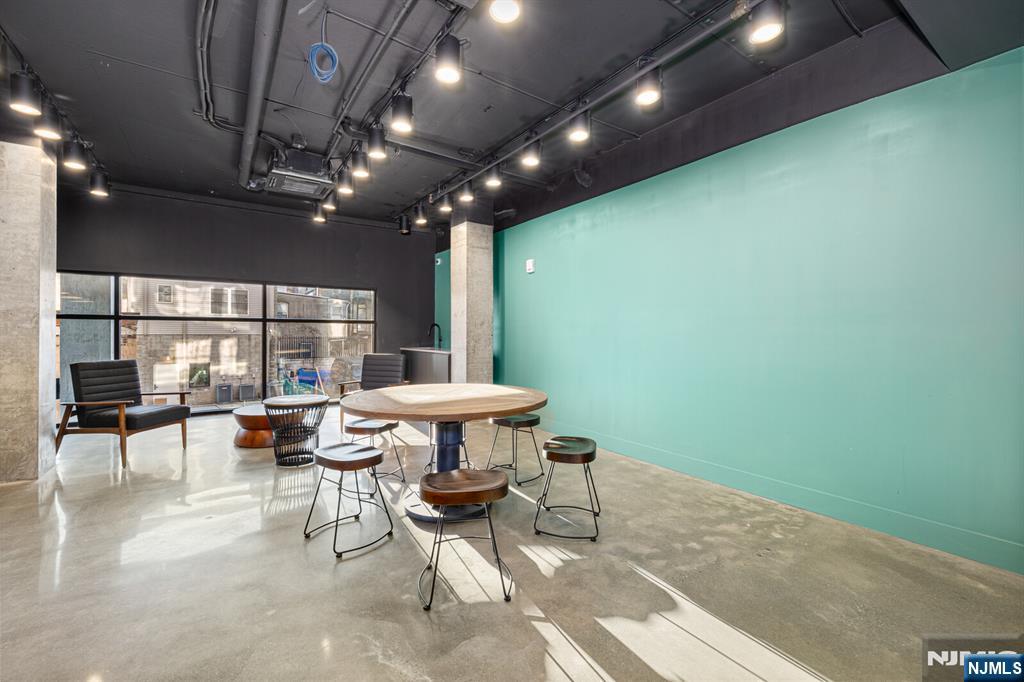 65 McWhorter Street, Unit 711 Newark, NJ 07105 - Photo 12 of 14 a view of a chairs and table in a room