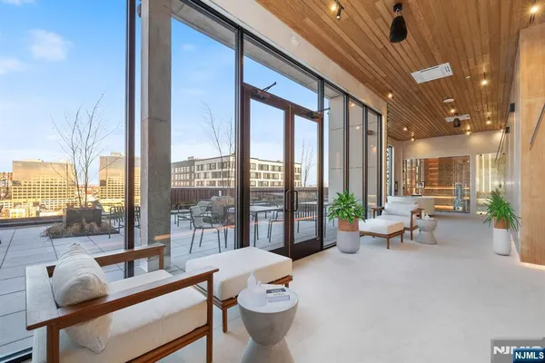 a living room with furniture and a floor to ceiling window