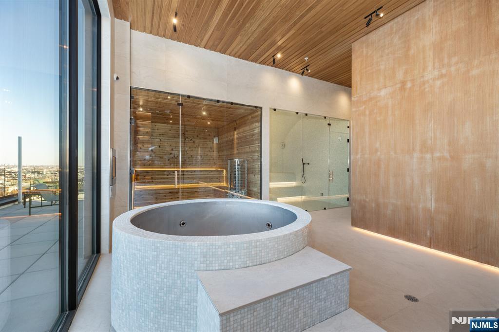 65 McWhorter Street, Unit 711 Newark, NJ 07105 - Photo 6 of 14 a spacious bathroom with a tub and shower