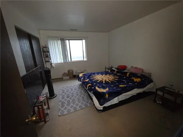 a bed sitting in a room next to a window