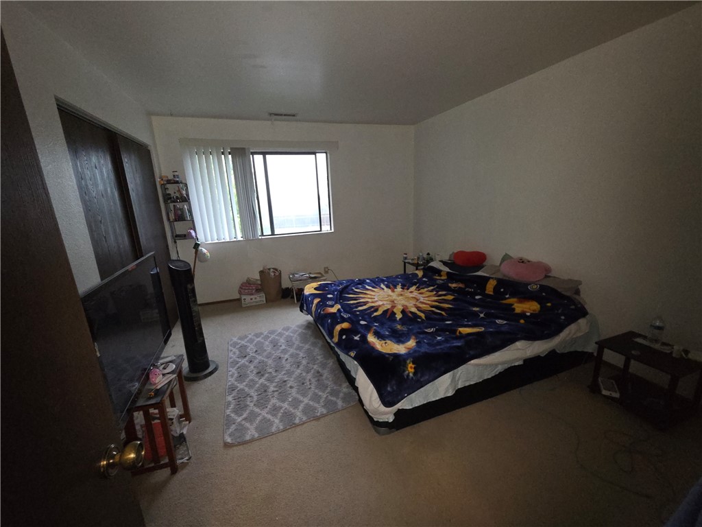 635 North Street Corning, CA 96021 - Photo 17 of 29 a bed sitting in a room next to a window