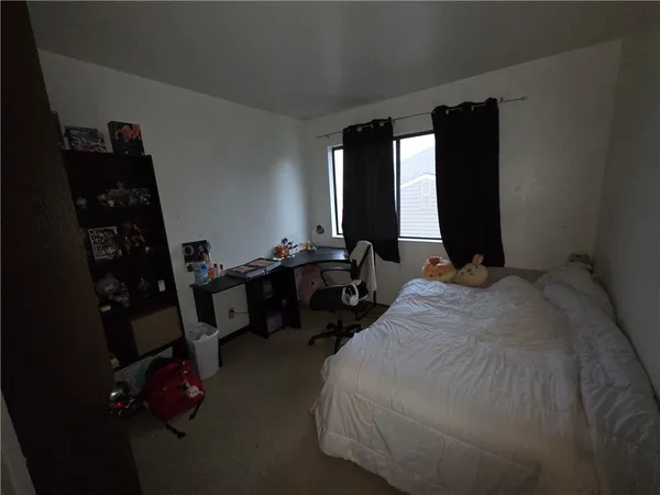 a bed room with a bed and a window