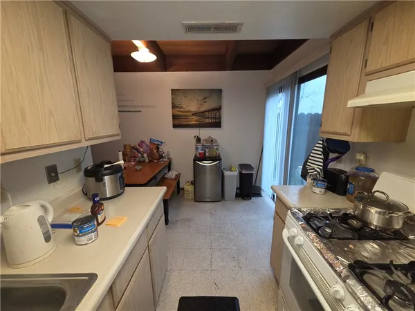 a kitchen with sink a stove and cabinets