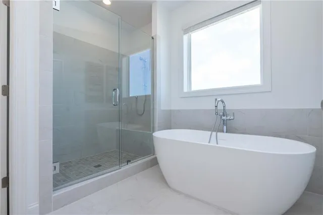 a white bath tub sitting next to a shower