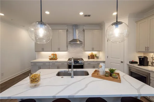 a kitchen with a sink a stove and chairs