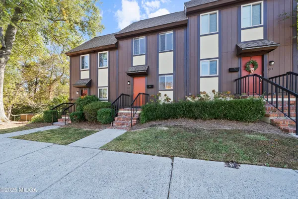 a front view of a brick house with a yard