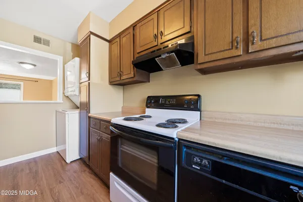 a kitchen with stainless steel appliances granite countertop a sink stove and cabinets