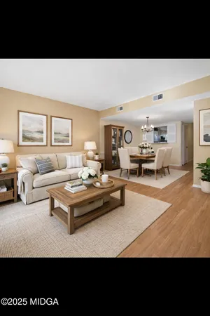 a living room with furniture a rug and a large window