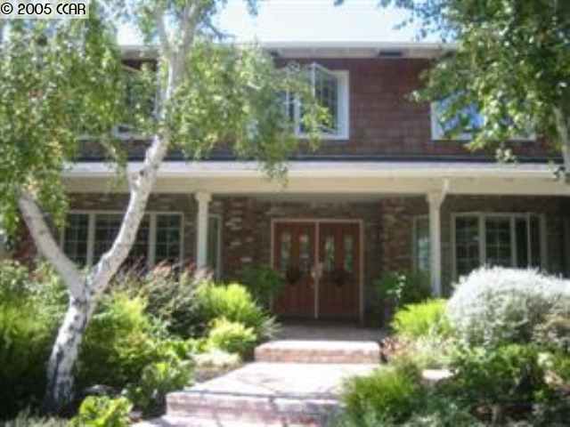 150 Sandringham Drive South Moraga, CA 94556 - Photo 1 of 1 a view of a house with potted plants and a table and chairs