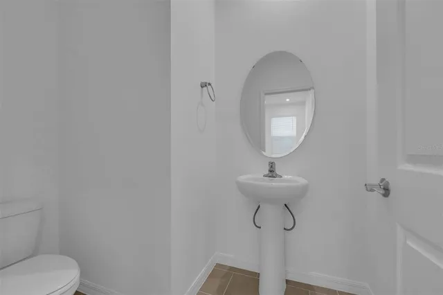 a bedroom with a bed lamp and window