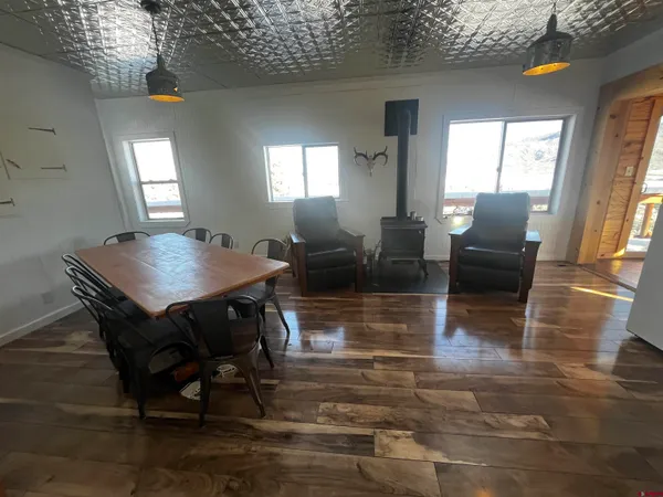 a view of a dining room with furniture and wooden floor