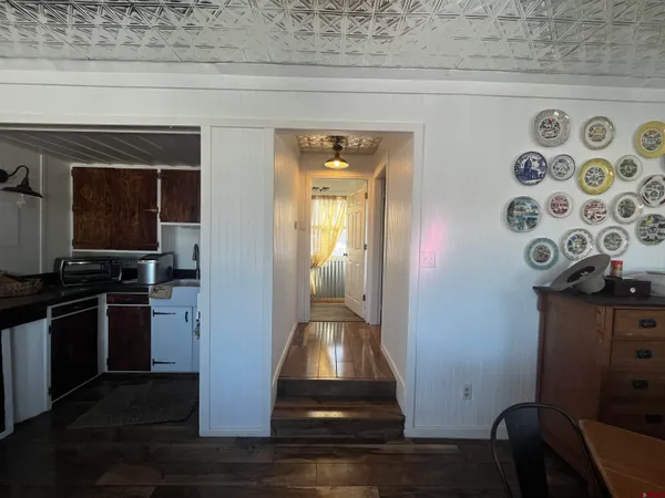 a view of a livingroom with wooden floor and a sink