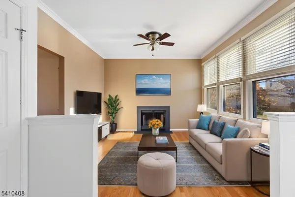 a living room with furniture a fireplace and a large window