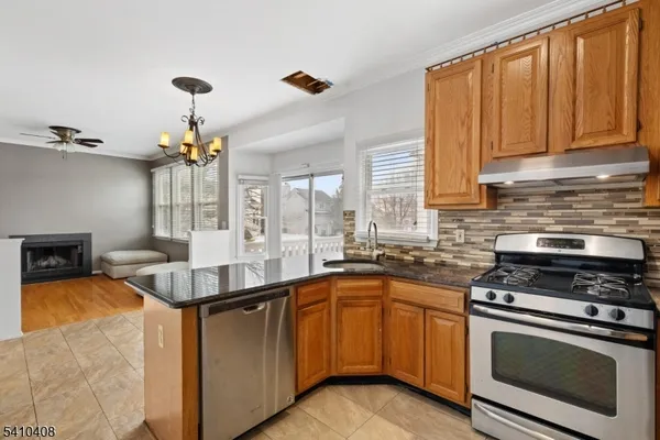 a kitchen with a sink stove and cabinets