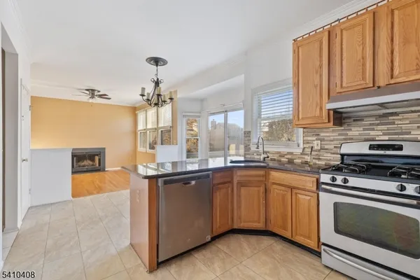 a kitchen with stainless steel appliances granite countertop a stove sink and cabinets