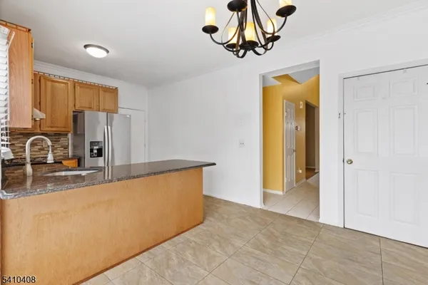 a view of a kitchen with a sink and cabinet