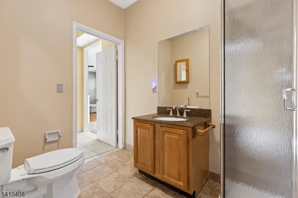 a view of bathroom with a toilet sink and mirror