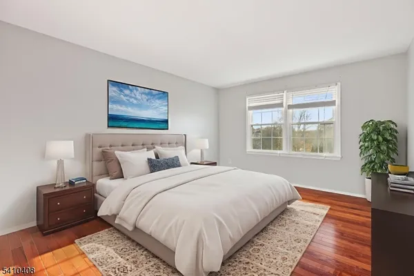 a bedroom with bed and a potted plant