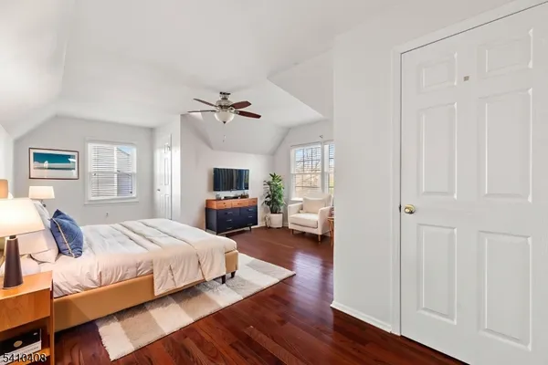 a bedroom with a bed couch and a window