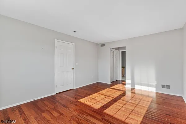 a view of a room with wooden floor