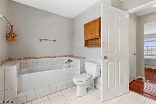a bathroom with a toilet a sink and bathtub