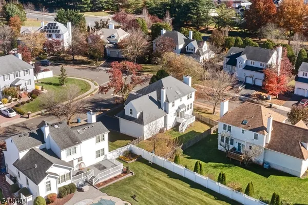 an aerial view of a house with swimming pool and outdoor seating