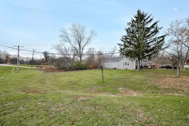 a view of a house with a yard and garage