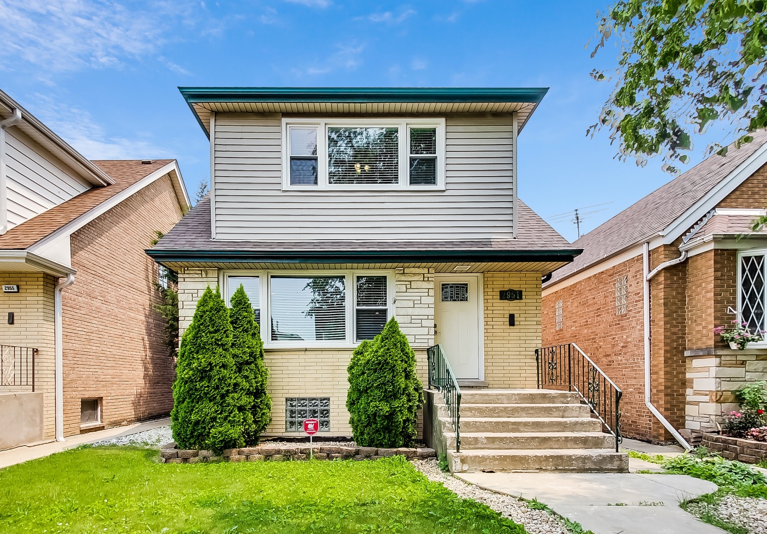 a front view of a house with a yard
