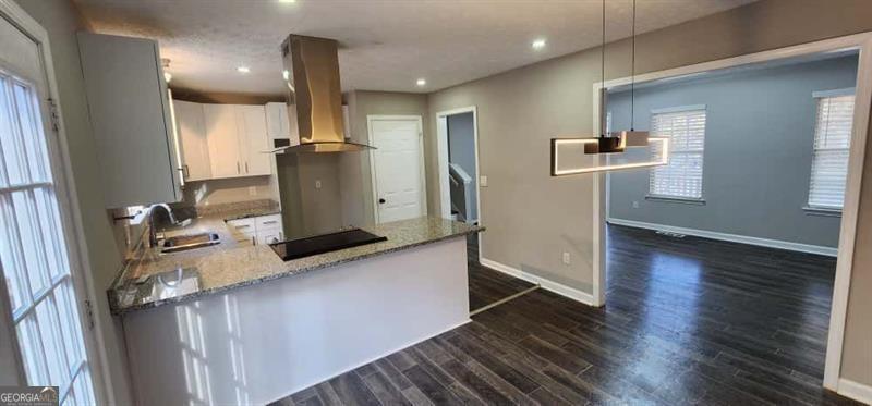 4872 Lewis Road Powder Springs, GA 30127 - Photo 12 of 42 a view of a kitchen with wooden floor and electronic appliances