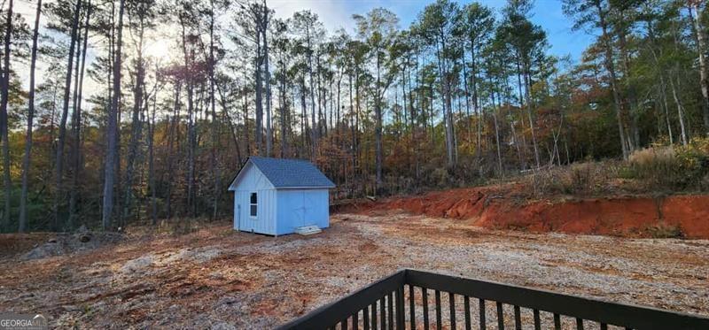 4872 Lewis Road Powder Springs, GA 30127 - Photo 16 of 42 a backyard of a house with a yard and large trees