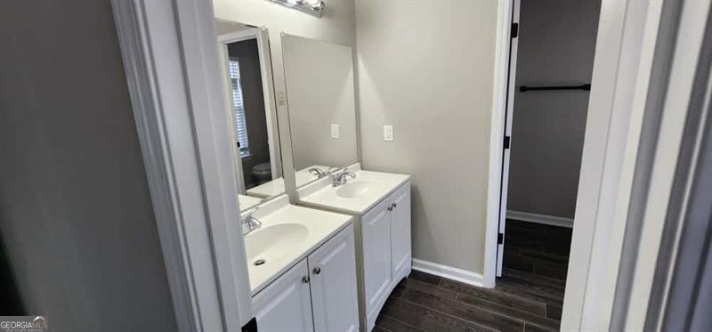 4872 Lewis Road Powder Springs, GA 30127 - Photo 22 of 42 a bathroom with a double vanity sink and a mirror