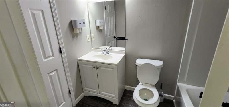 4872 Lewis Road Powder Springs, GA 30127 - Photo 25 of 42 a bathroom with a toilet a sink and a mirror