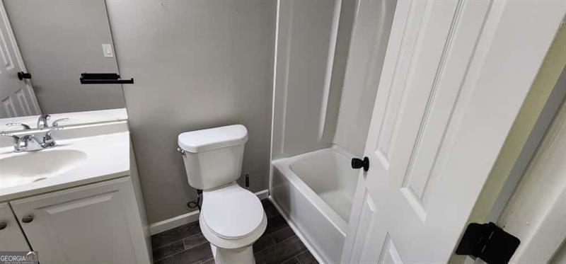 4872 Lewis Road Powder Springs, GA 30127 - Photo 30 of 42 a white toilet sitting next to a bathroom sink