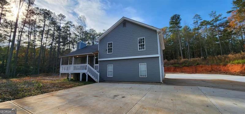 4872 Lewis Road Powder Springs, GA 30127 - Photo 32 of 42 a front view of a house with a yard and garage