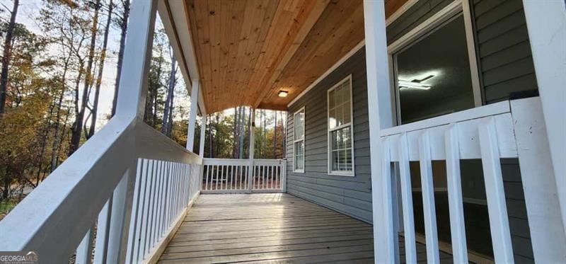 4872 Lewis Road Powder Springs, GA 30127 - Photo 6 of 42 a view of deck with wooden floor and fence