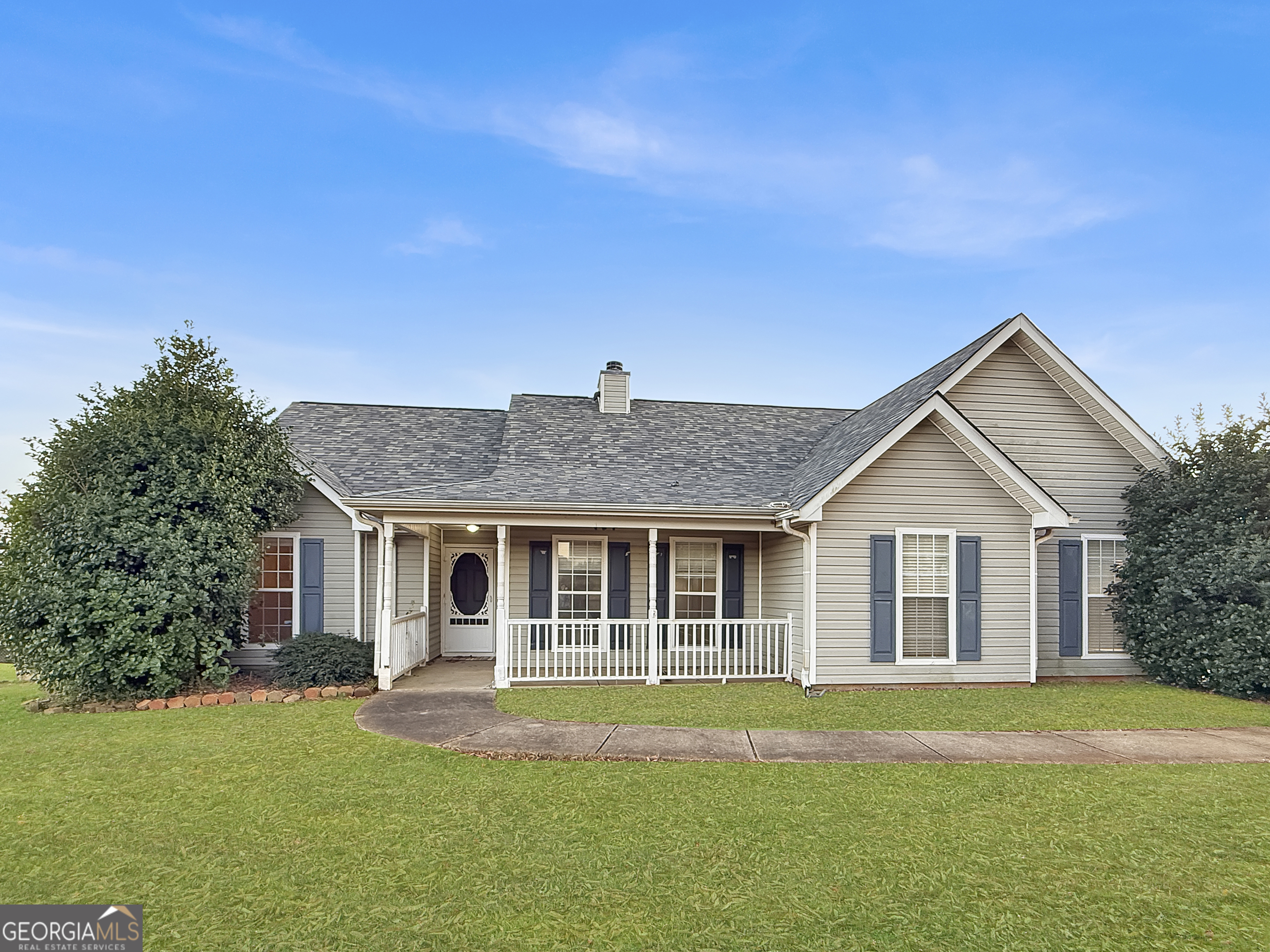 231 Ferguson Avenue Locust Grove, GA 30248 - Photo 1 of 26 a front view of a house with a garden