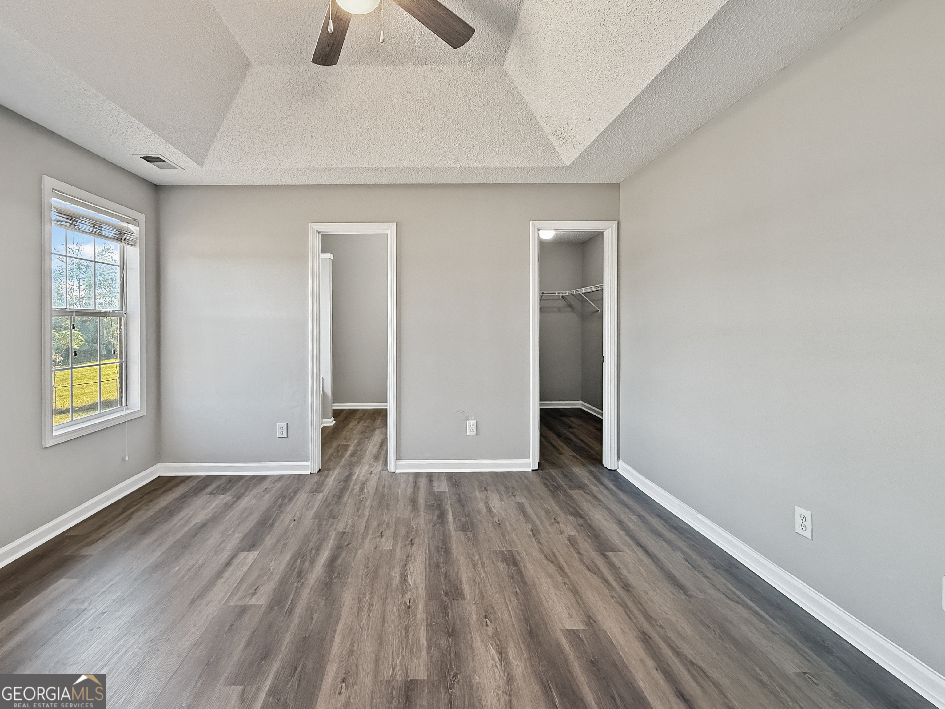 231 Ferguson Avenue Locust Grove, GA 30248 - Photo 11 of 26 an empty room with wooden floor and windows
