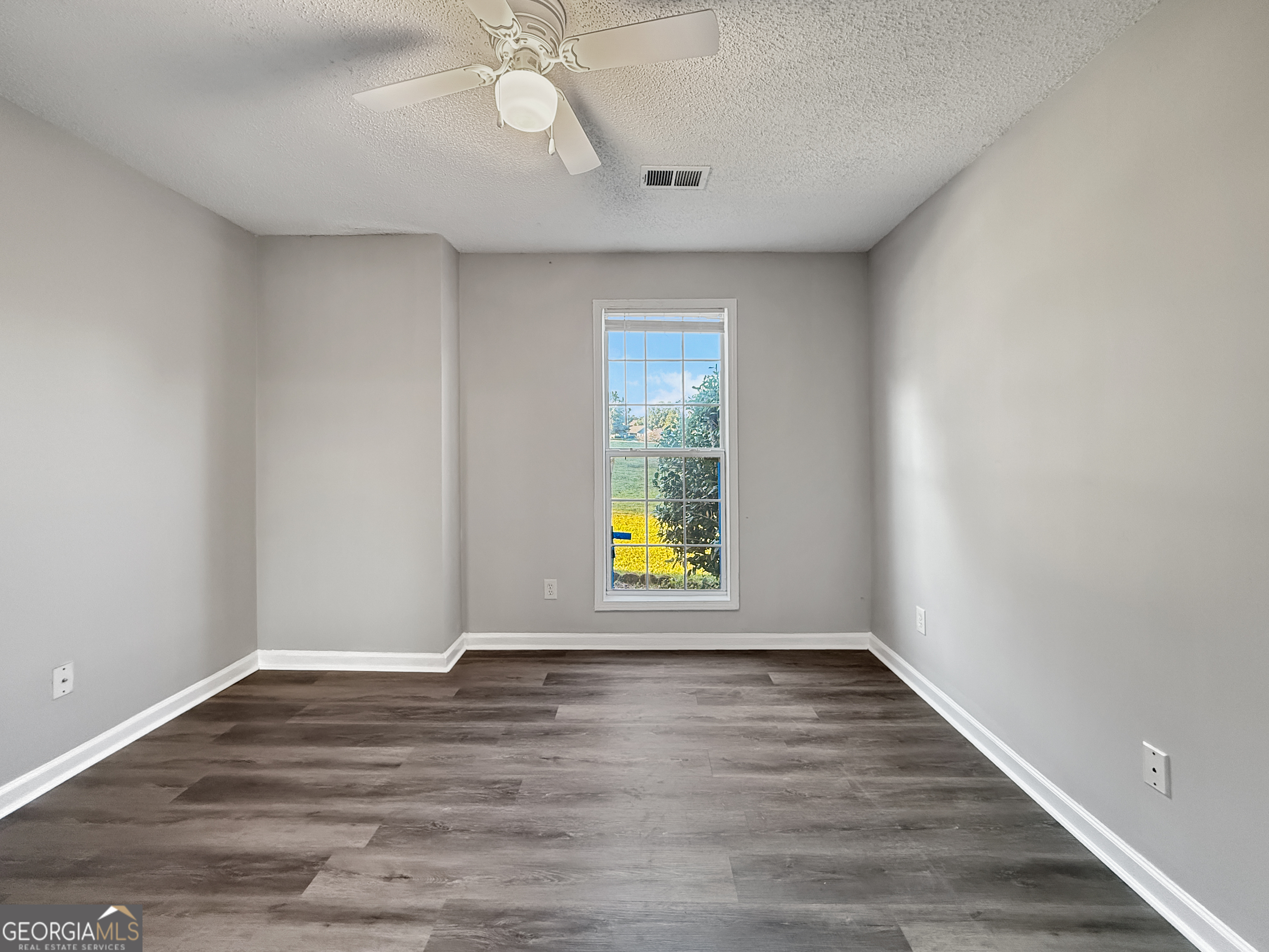 231 Ferguson Avenue Locust Grove, GA 30248 - Photo 16 of 26 a view of empty room with wooden floor and fan