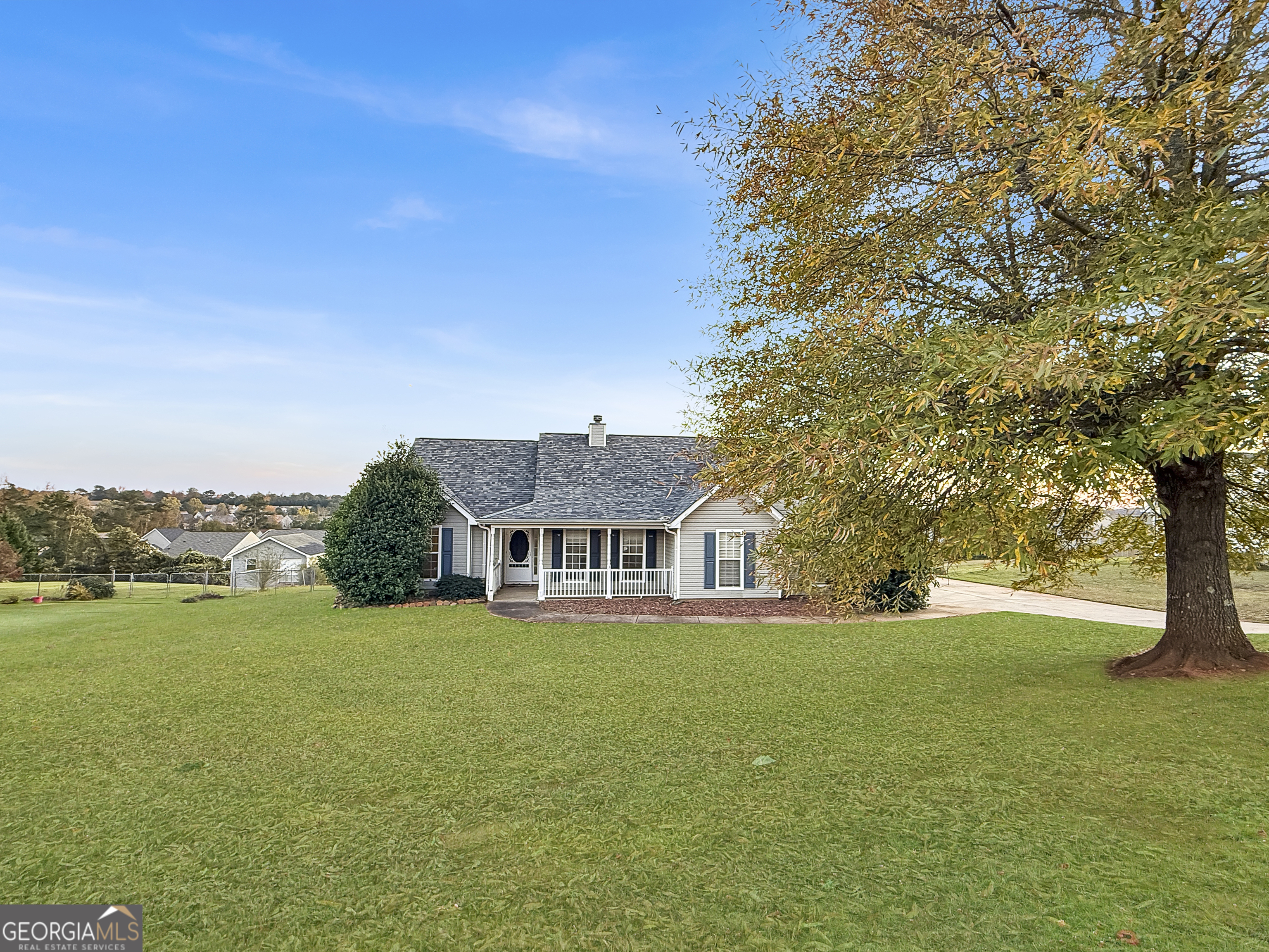 231 Ferguson Avenue Locust Grove, GA 30248 - Photo 2 of 26 a view of a house with a big yard and large trees