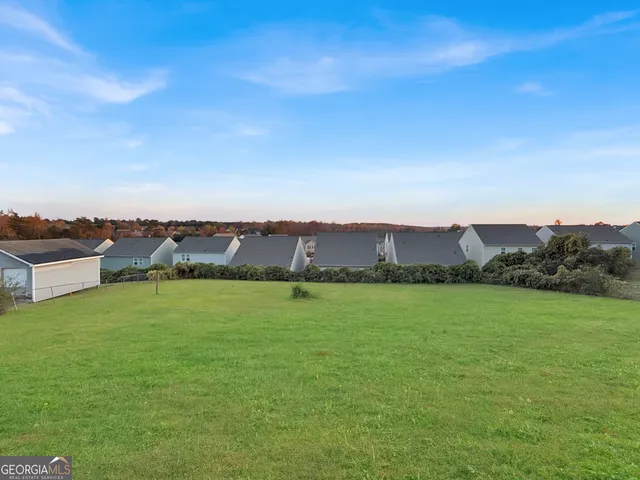 a view of a city with lawn chairs and large trees