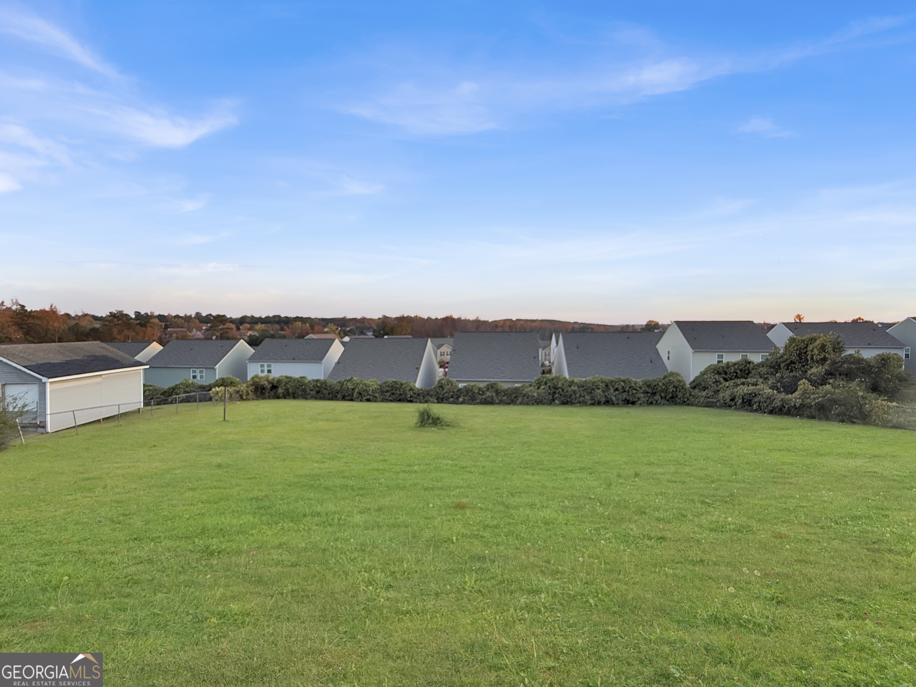 231 Ferguson Avenue Locust Grove, GA 30248 - Photo 22 of 26 a view of a city with lawn chairs and large trees