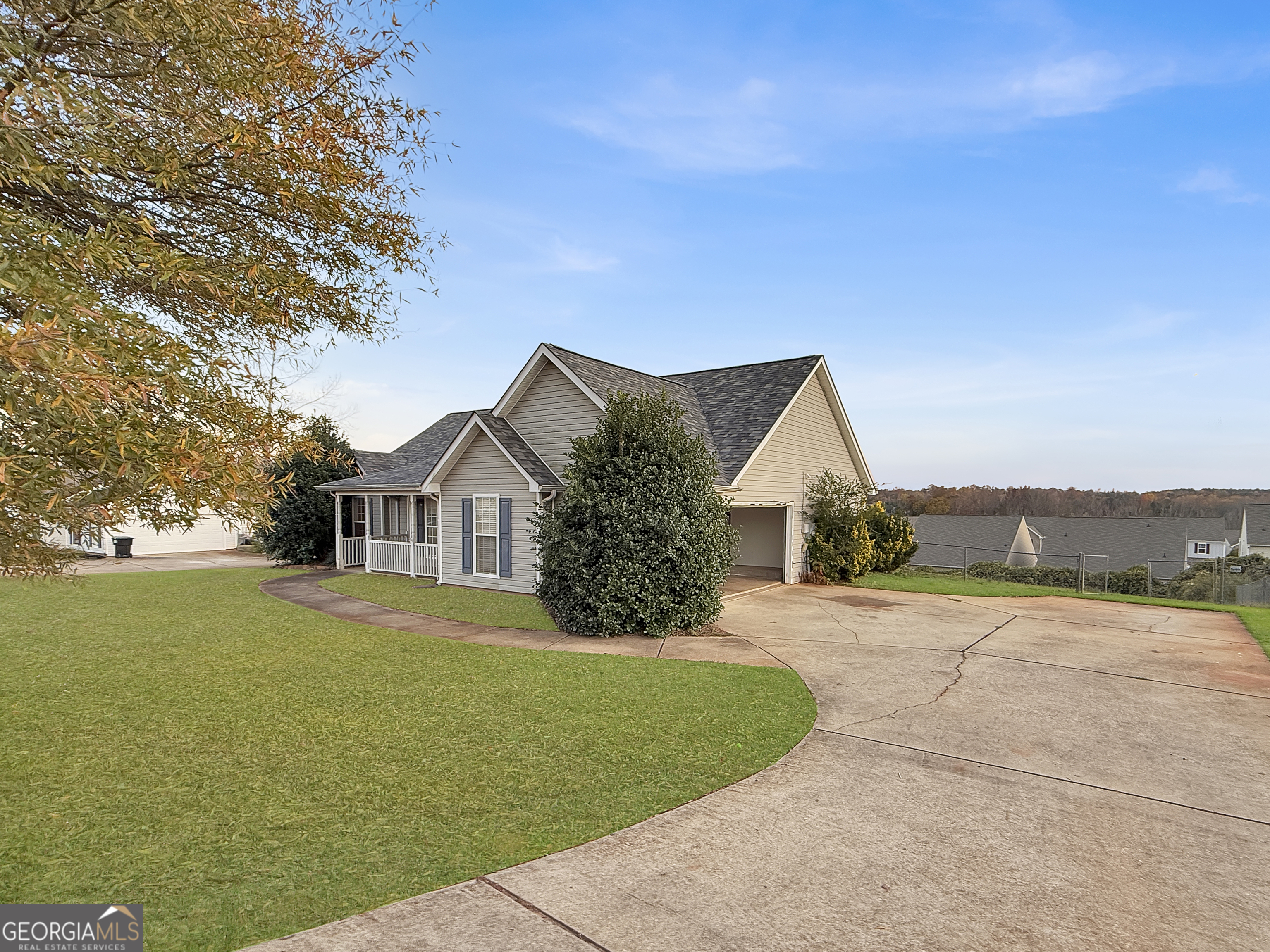 231 Ferguson Avenue Locust Grove, GA 30248 - Photo 3 of 26 a front view of a house with a garden and yard