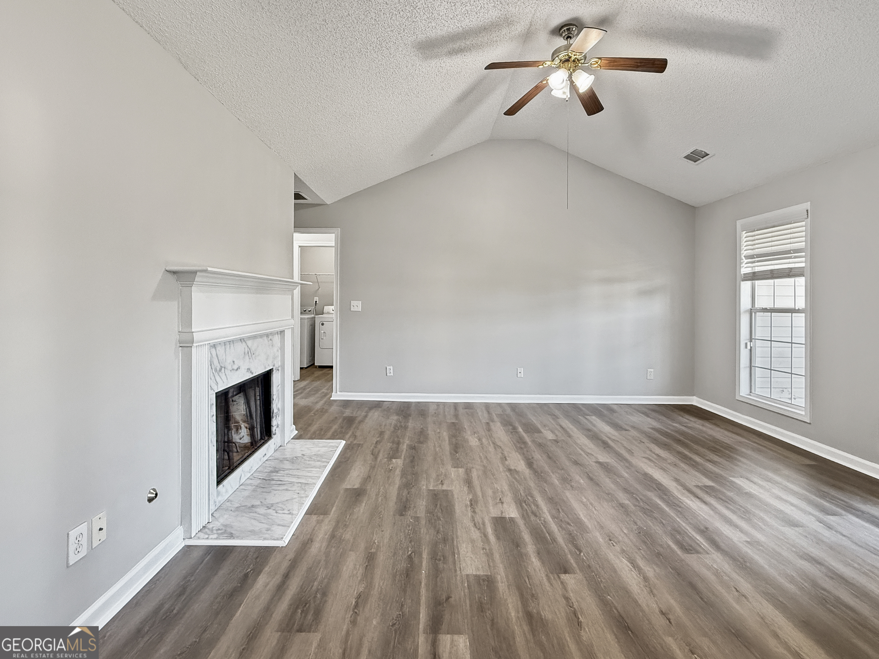 231 Ferguson Avenue Locust Grove, GA 30248 - Photo 5 of 26 wooden floor in an empty room with a fireplace