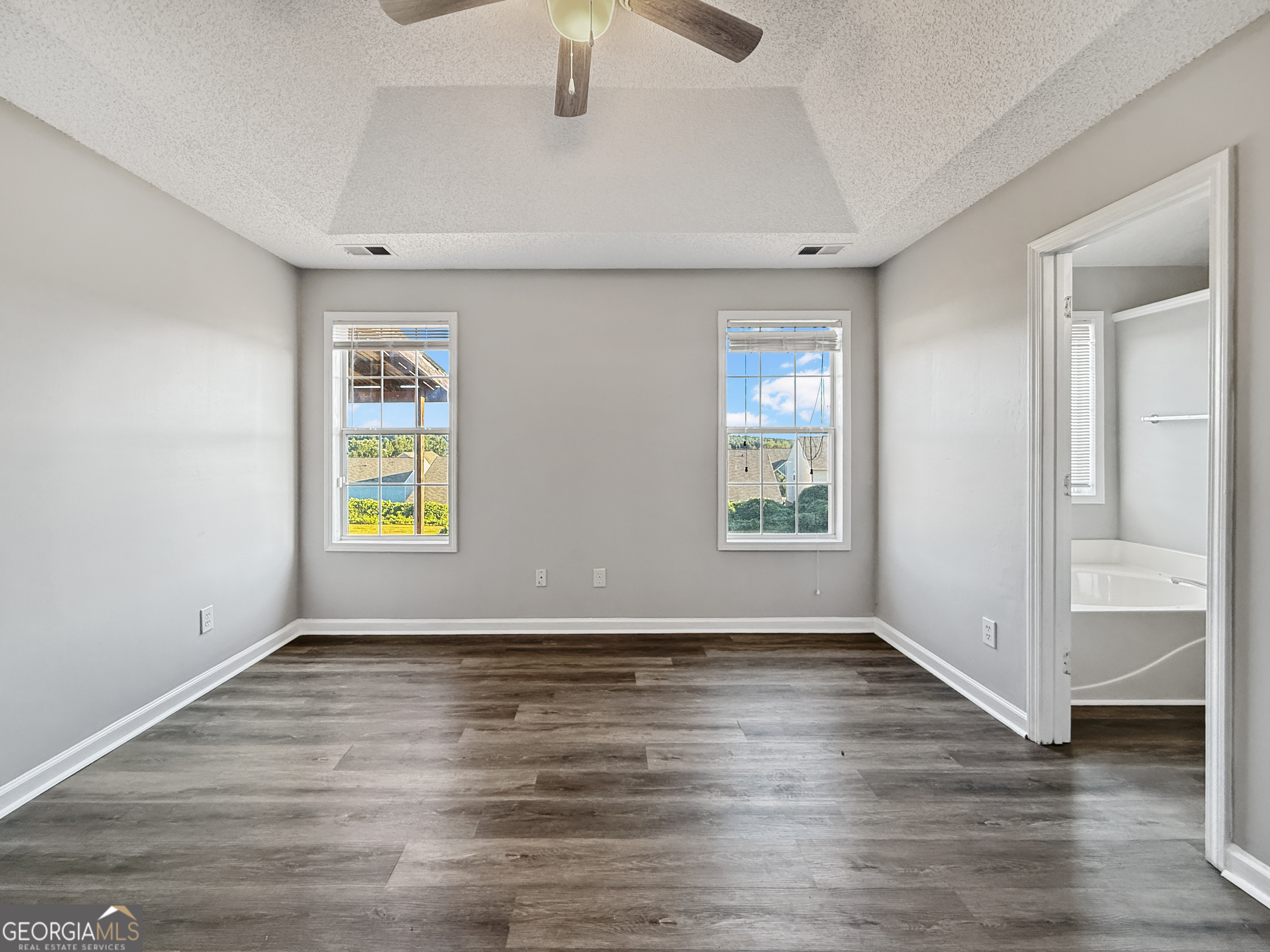 231 Ferguson Avenue Locust Grove, GA 30248 - Photo 10 of 26 wooden floor in an empty room with a window
