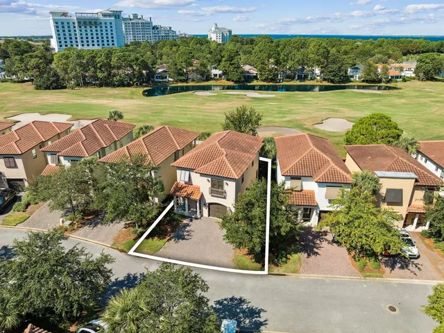 an aerial view of residential houses with outdoor space and swimming pool