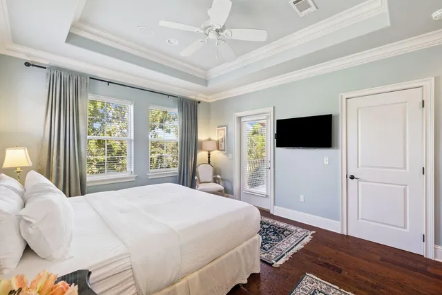 a bedroom with a bed tv and a window