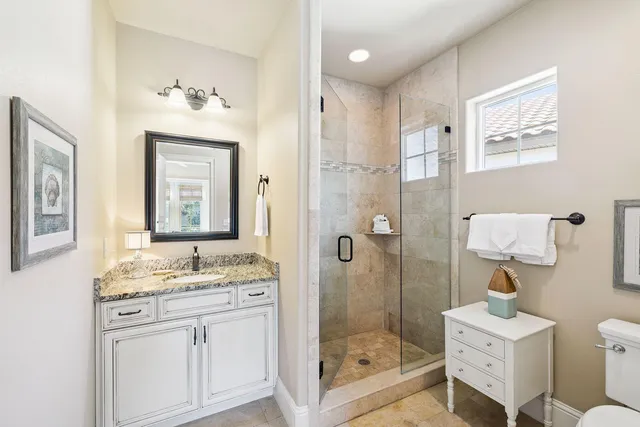 a bathroom with a sink a toilet and shower