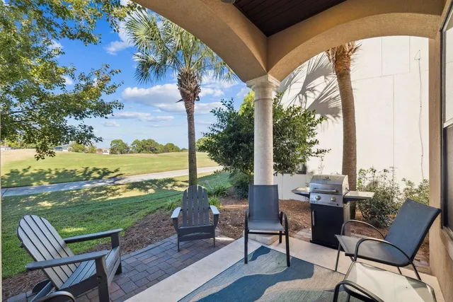 a view of a chairs and table in patio with a lake view
